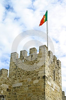 Portuguese flag waving on tower of Sao Jorge Castle. Lisbon, Portugal