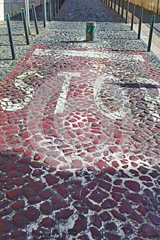 Portuguese Pavement Known as CalÃÂ§ada Portuguesa Made of Small White-Red-Black Stones in Mosaic Pattern With Stop Sign photo