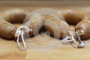 Portuguese smoked sausage called alheira on wooden board