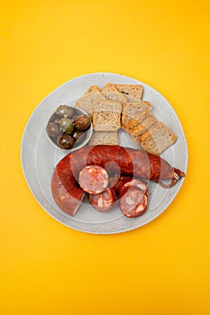 portuguese smoked sausage chourico with olives and toasts