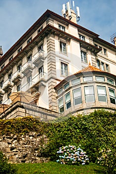 Portuguese-styled building with red tyles on the hill with hortensia bush, Hydrangea macrophylla, Pousada Viana do Castelo Hotel,