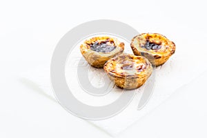 Portuguese tarts on the top on napkin