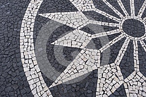 Portuguese traditional black and white pavement made from calcada tiling.