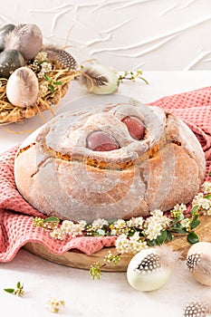 Portuguese traditional Easter cake with eggs. Typical Folar de Vale de Ilhavo, Aveiro, Portugal. Blossom flowers and colorful