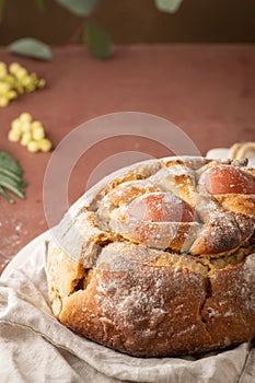 Portuguese traditional Easter cake with eggs. Typical Folar de Vale de Ilhavo, Aveiro, Portugal. Blossom flowers and colorful