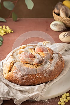 Portuguese traditional Easter cake with eggs. Typical Folar de Vale de Ilhavo, Aveiro, Portugal. Blossom flowers and colorful