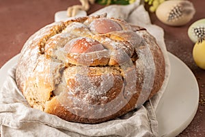 Portuguese traditional Easter cake with eggs. Typical Folar de Vale de Ilhavo, Aveiro, Portugal. Blossom flowers and colorful