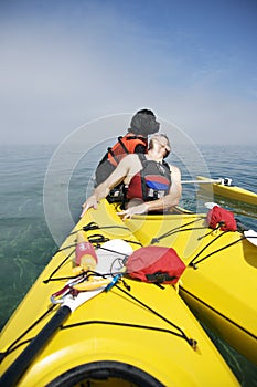 Portuguese Water Dog on Yellow Kayak photo