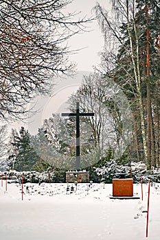 Porvoo, Finland - December 25, 2018: old town cemetery grave yard with big metal cross in winter snow