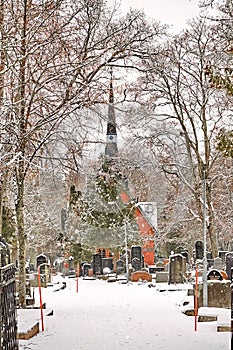 Porvoo, Finland - December 25, 2018: old town cemetery grave yard with Finnish Kirche church with winter snow