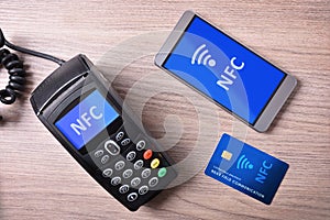 POS card and mobile on wood table nfc transmision system photo