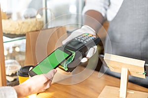 POS payment terminal in hand of a waiter
