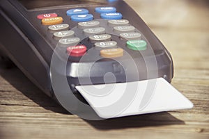 POS payment terminal on wooden background