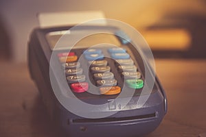 POS payment terminal on wooden background