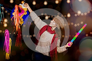 Posada Mexicana, Mexican Christmas, Latin Girl Holding a colorful Piata and celebrating a traditional Posada in Mexico