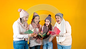 Posada Mexicana, Mexican family Singing carols at Christmas, three generations of women in Mexico Latin America