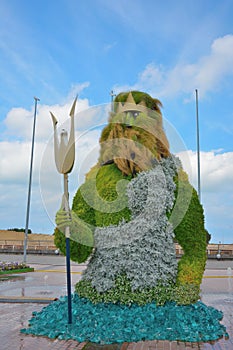 Poseidon sculpture made from flowers is in Greek mythology the god who rules over the sea