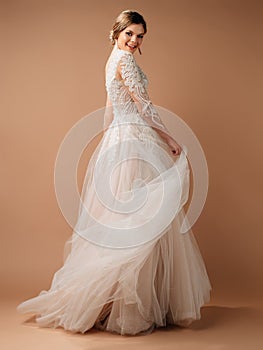 Posh wedding dress. Fashionable bridal gown with tender french lace and beads, long sleeves, weightless tulle skirt.