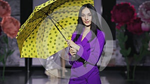 Posing attractive girl hold umbrella catwalk model show vogue. Woman on podium.