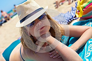 A posing girl laying on a beach