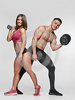 Posing Man and woman with dumbbells