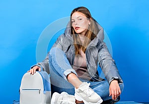 Posing for photo. flu and cold season. Leather bag fashion. girl in puffed coat. faux fur fashion. warm winter clothing