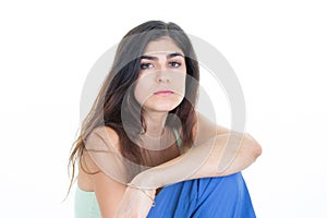 Posing portrait cute beautiful young woman with arms crossed sitting In white Studio background