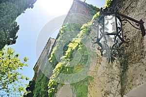 Positano, Amalfi coast, Italy - view of a lamp, plants and building facade