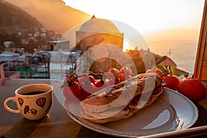 Positano - Breakfast during sunrise with view on the scenic village Positano at the Amalfi Coast, Italy, Europe