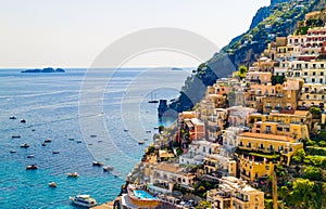 Positano houses with ancient turret  sea, Li galli isles and boats in background