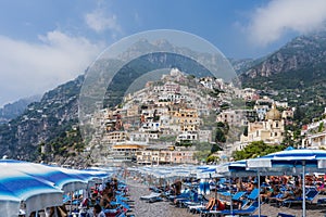 Positano, Italy - August 12, 2019: People enjoy summer beach time at Positano in Amalfi Coast