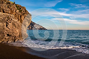 Positano - Scenic view at the Fornillo Beach in the coastal town Positano at Amalfi Coast, Italy. Praiano in distance