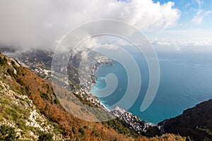 Positano - Scenic view from hiking trail on clouds covering the coastal town Positano at the Amalfi Coast, Campania, Italy.