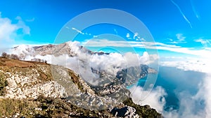 Positano - Scenic view from Monte Comune on clouds covering the coastal town Positano at the Amalfi Coast, Campania, Italy.