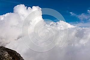 Positano - Scenic view from Monte Comune on thick clouds covering the coastal town Positano at the Amalfi Coast, Campania, Italy.