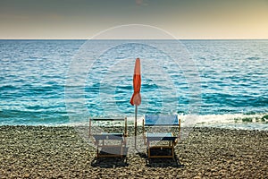 Positano secuded beach with chairs and parasol sunshade, amalfi coast, Italy