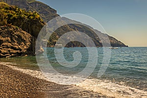 Positano secuded beach and cliffs at summer sunny day, amalfi coast, Italy