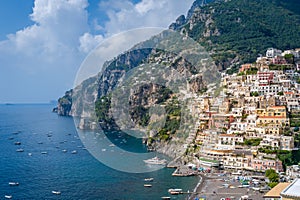 Positano town and sea bay with boats moored