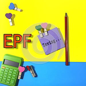 Position the calculator, pencil and note paper wording Saving with love clamps and also a written EPF on background.