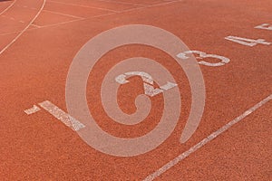 Position runner athlete start point row of number in running track sports stadium. business position start up concept