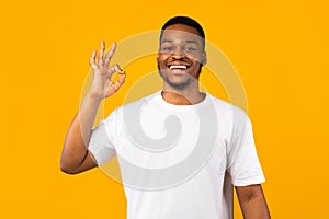 Positive African Man Gesturing OK Sign On Yellow Studio Background