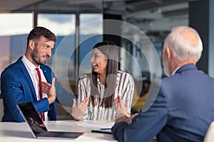 Positive aged couple consulting with insurance agent