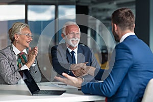 Positive aged couple consulting with insurance agent