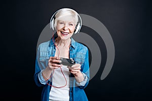 Positive aged woman playing video games