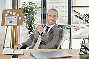 positive ambitious businessman in grey suit