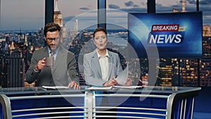 Positive anchors talking newscast at modern channel closeup. Man woman reporting