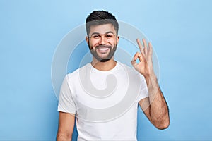 Positive attractive young man showing ring gesture with fingers