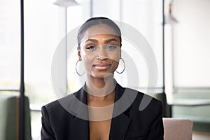 Positive beautiful African American businesswoman in formal jacket head shot