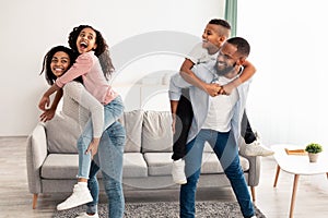 Portrait of happy black family having fun at home