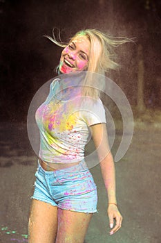 Positive blonde woman in white t shirt with hair in wind covered